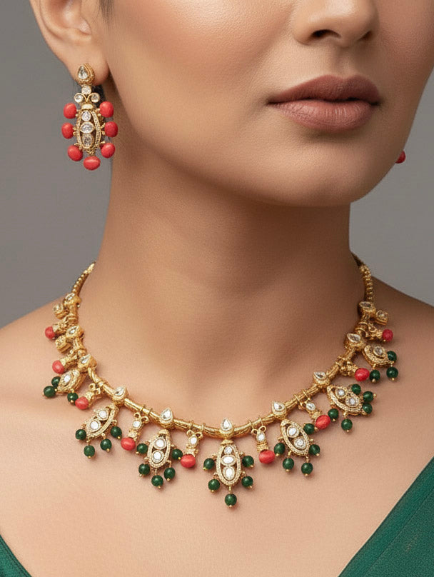 Close-up of a woman wearing an ornate traditional (Gold Polish) Collar jewellery set and earrings with Colored Stone, Beads and American Diamonds. Festive Diwali outfit paired with a colorful Colored Stone necklace. Mehendi ceremony look completed with a Colored Stone  jewelry set.