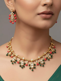 Close-up of a woman wearing an ornate traditional (Gold Polish) Collar jewellery set and earrings with Colored Stone, Beads and American Diamonds. Festive Diwali outfit paired with a colorful Colored Stone necklace. Mehendi ceremony look completed with a Colored Stone  jewelry set.
