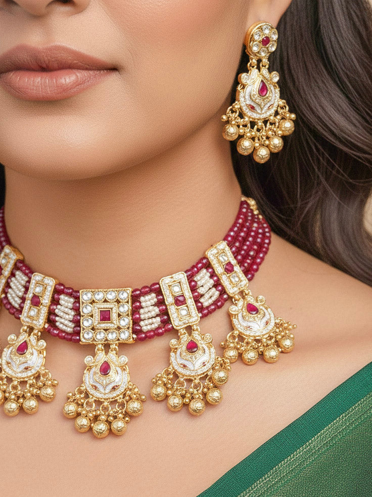Close-up of a woman wearing an ornate traditional Ruby Pink Meenakari gold Choker jewellery set and earrings and maangtikka with Colored Stones, Pearls, Meenakari, Kundan and Crystal Beads. Festive Diwali outfit paired with a colorful Meenakari necklace. Close-up of detailed enamel craftsmanship in Meenakari jewelry.