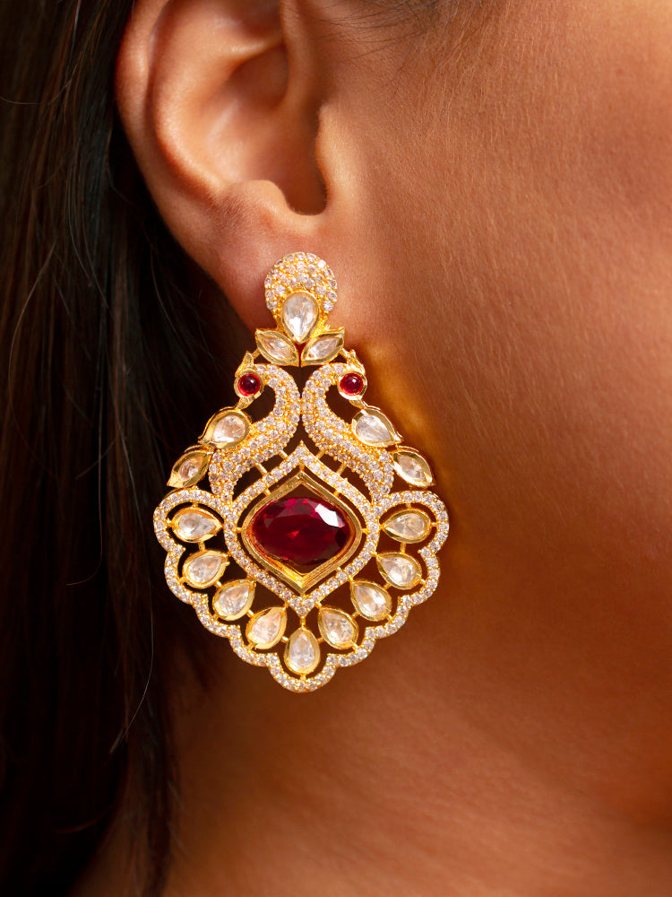 Close-up of a woman wearing an ornate traditional Red (gold Polish) Diamond  Earrings with American Diamond, Kundan and Colored Stones. Elegant festive look with a high-quality imitation American diamond Earrings. A graceful woman wearing a trending American diamond necklace for a 2026 wedding celebration.