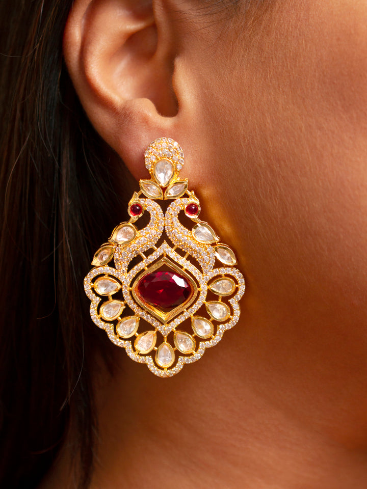 Close-up of a woman wearing an ornate traditional Red (gold Polish) Diamond  Earrings with American Diamond, Kundan and Colored Stones. Elegant festive look with a high-quality imitation American diamond Earrings. A graceful woman wearing a trending American diamond necklace for a 2026 wedding celebration.