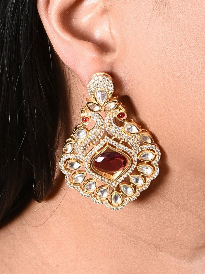 Close-up of a woman wearing an ornate traditional Red (gold Polish) Diamond  Earrings with American Diamond, Kundan and Colored Stones. Elegant festive look with a high-quality imitation American diamond Earrings. A graceful woman wearing a trending American diamond necklace for a 2026 wedding celebration.