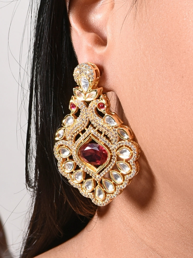 Close-up of a woman wearing an ornate traditional Red (gold Polish) Diamond  Earrings with American Diamond, Kundan and Colored Stones. Elegant festive look with a high-quality imitation American diamond Earrings. A graceful woman wearing a trending American diamond necklace for a 2026 wedding celebration.