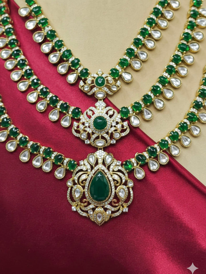 Close-up of an ornate traditional Green Heritage gold Long Layered jewellery set and earrings with colored Stone, Kundan and American Diamond. Mehendi ceremony styling featuring a premium heritage artificial jewelry piece. Styling a vintage heritage artificial necklace for a reception party.