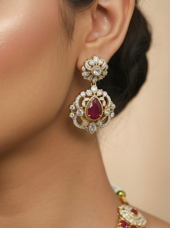 Close-up of a woman wearing an ornate traditional Red Heritage gold Long Layered jewellery set and earrings with colored Stone, Kundan and American Diamond. Mehendi ceremony styling featuring a premium heritage artificial jewelry piece. Traditional Indian look completed with a heritage artificial jewelry set.