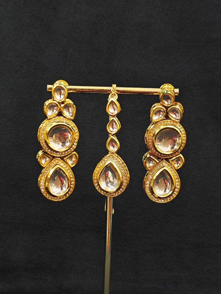 Close-up of an ornate traditional (Gold Polish) White Collar jewellery set and earrings and maangtikka with Kundan and American Diamonds. A trending Kundan artificial jewelry for wedding season in India. Bride wearing a royal Kundan artificial necklace for wedding rituals.