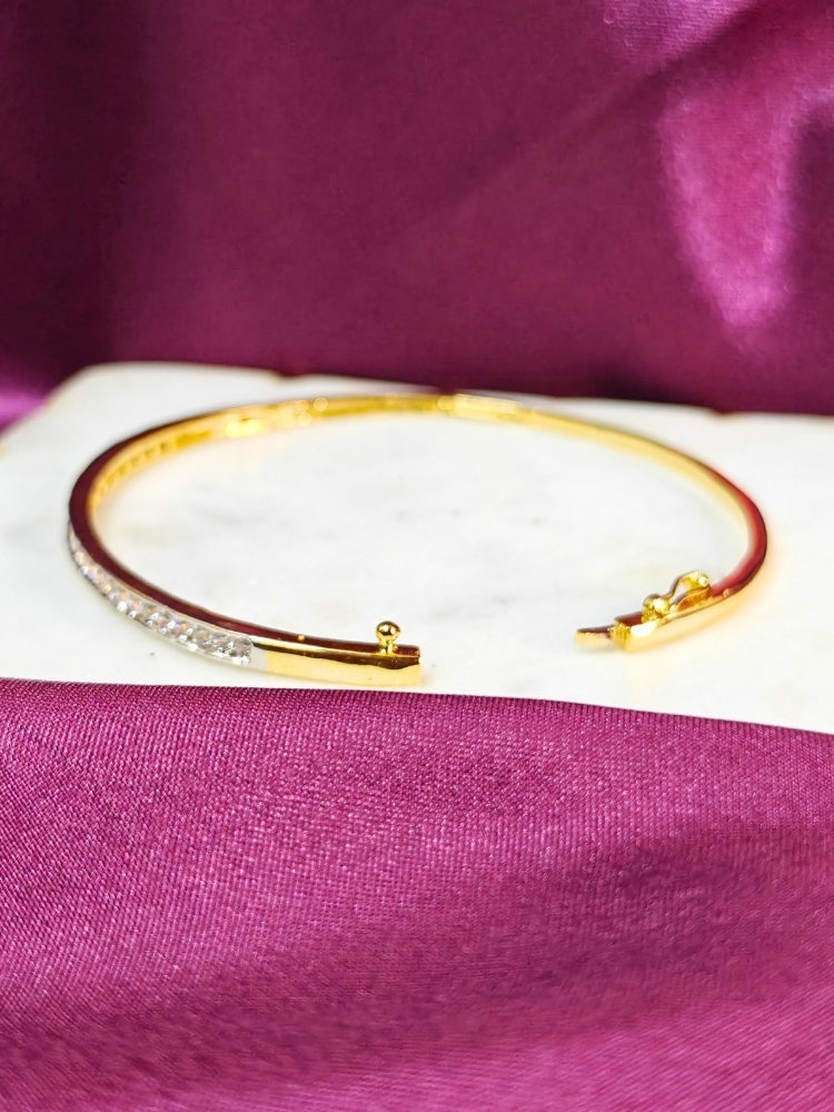 Close-up of a woman wearing an ornate Western (Gold & Silver Polish) Bracelet with American Diamond. Festive outfit paired with a premium imitation American Diamond bracelet in India. Close-up of skin-friendly artificial jewelry American Diamond bracelet in India.
