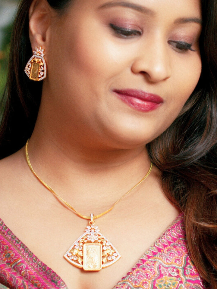 Close-up of a woman wearing an ornate Indo-Western gold Diamond Ginni Pendant set and earrings with American Diamonds. Elegant festive look with a high-quality imitation American diamond Ginni Pendant  set. Party wear outfit completed with a lightweight American diamond Ginni Pendant Set.