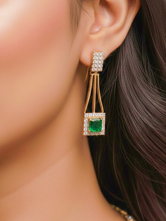 Close-up of a woman wearing an ornate Indo-western Green (gold Polish) Collar Layered Diamond jewellery set and earrings with American Diamond and Colored Stone. Party wear outfit completed with a lightweight American diamond necklace. Reception-ready look featuring a statement American diamond jewelry set.