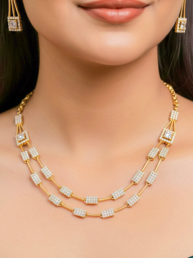 Close-up of a woman wearing an ornate Indo-western white (gold Polish) Collar Layered Diamond jewellery set and earrings with American Diamond. Party wear outfit completed with a lightweight American diamond necklace. Reception-ready look featuring a statement American diamond jewelry set.