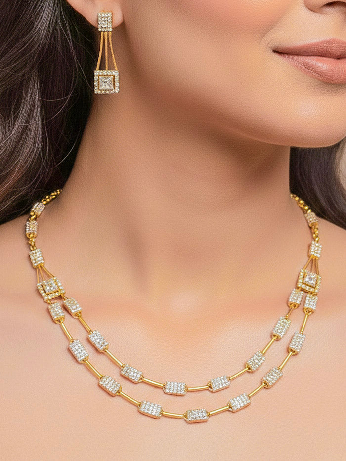 Close-up of a woman wearing an ornate Indo-western white (gold Polish) Collar Layered Diamond jewellery set and earrings with American Diamond. Party wear outfit completed with a lightweight American diamond necklace. Reception-ready look featuring a statement American diamond jewelry set.