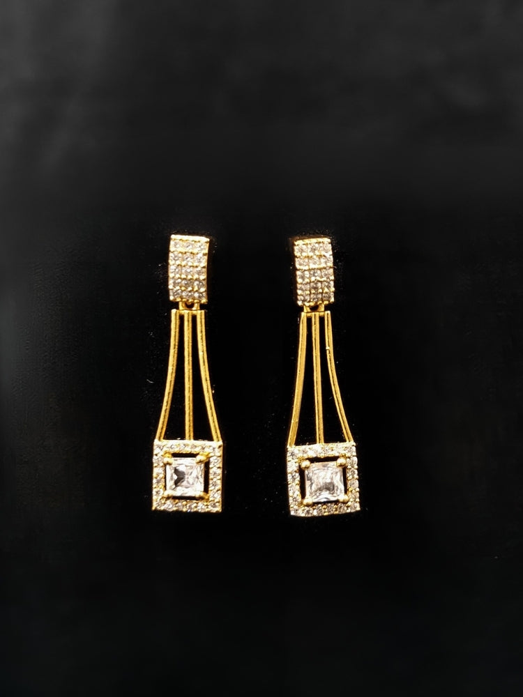 Close-up of an ornate Indo-western white (gold Polish) Collar Layered Diamond jewellery set and earrings with American Diamond. Party wear outfit completed with a lightweight American diamond necklace. Reception-ready look featuring a statement American diamond jewelry set.