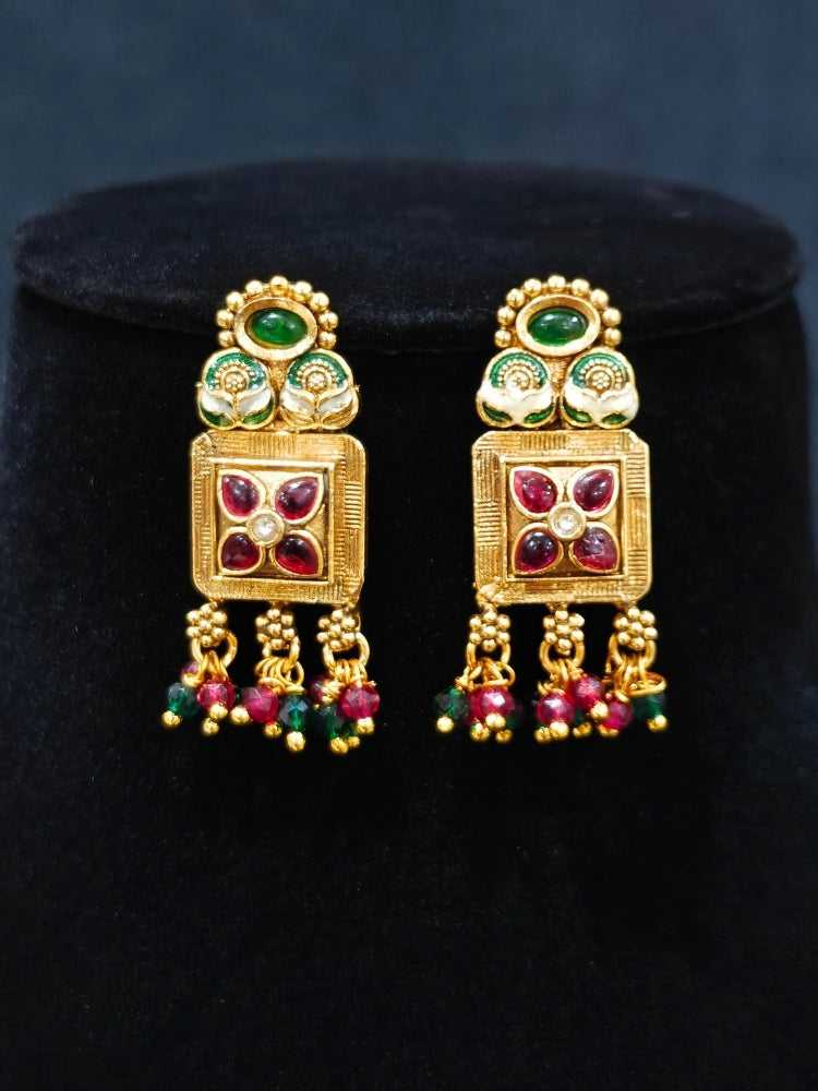 Close-up of an ornate traditional (Gold Polish) Pink & Green Long jewellery set and earrings with Pearls, Green & Pink Crystal Beads and Meenakari. Festive Diwali outfit paired with a colorful Meenakari necklace. Wedding function styling with a premium Meenakari imitation necklace.