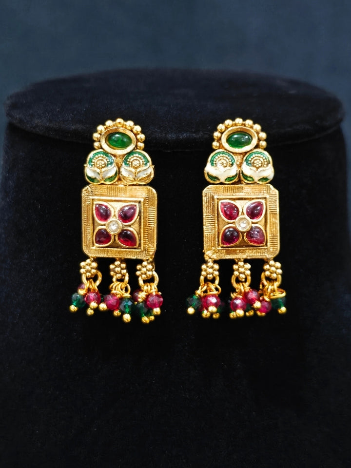 Close-up of an ornate traditional (Gold Polish) Pink & Green Long jewellery set and earrings with Pearls, Green & Pink Crystal Beads and Meenakari. Festive Diwali outfit paired with a colorful Meenakari necklace. Wedding function styling with a premium Meenakari imitation necklace.