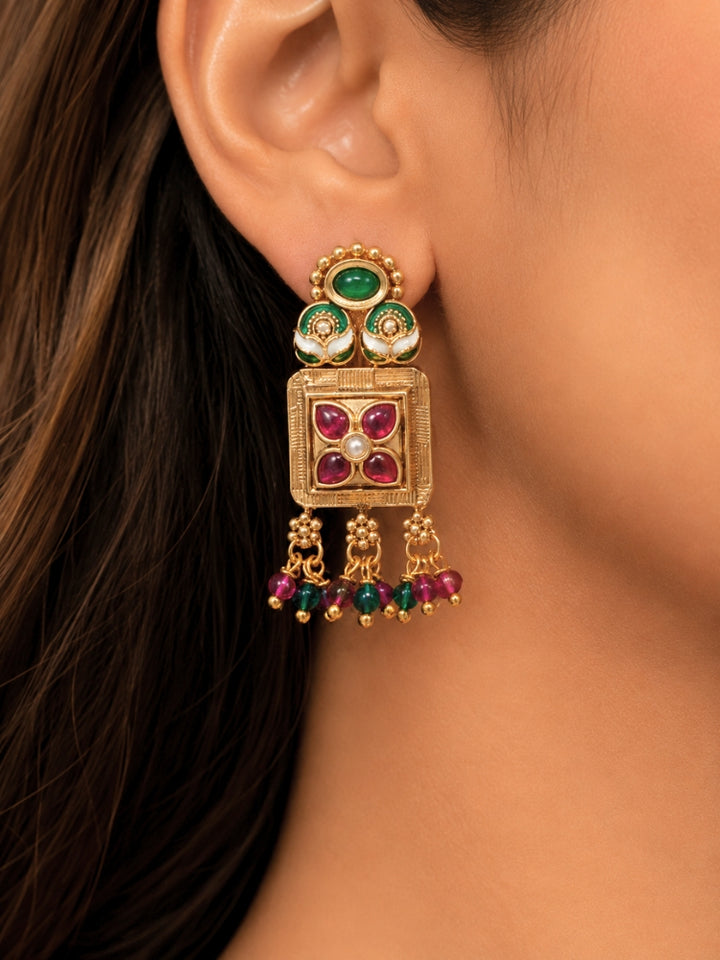 Close-up of a women wearing an ornate traditional (Gold Polish) Pink & Green Long jewellery set and earrings with Pearls, Green & Pink Crystal Beads and Meenakari. Festive Diwali outfit paired with a colorful Meenakari necklace. Wedding function styling with a premium Meenakari imitation necklace.
