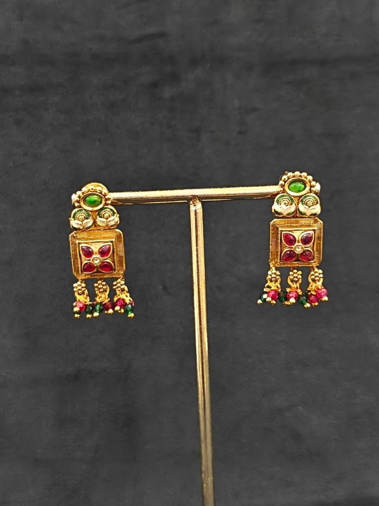 Close-up of an ornate traditional (Gold Polish) Pink & Green Long jewellery set and earrings with Pearls, Green & Pink Crystal Beads and Meenakari. Festive Diwali outfit paired with a colorful Meenakari necklace. Wedding function styling with a premium Meenakari imitation necklace.