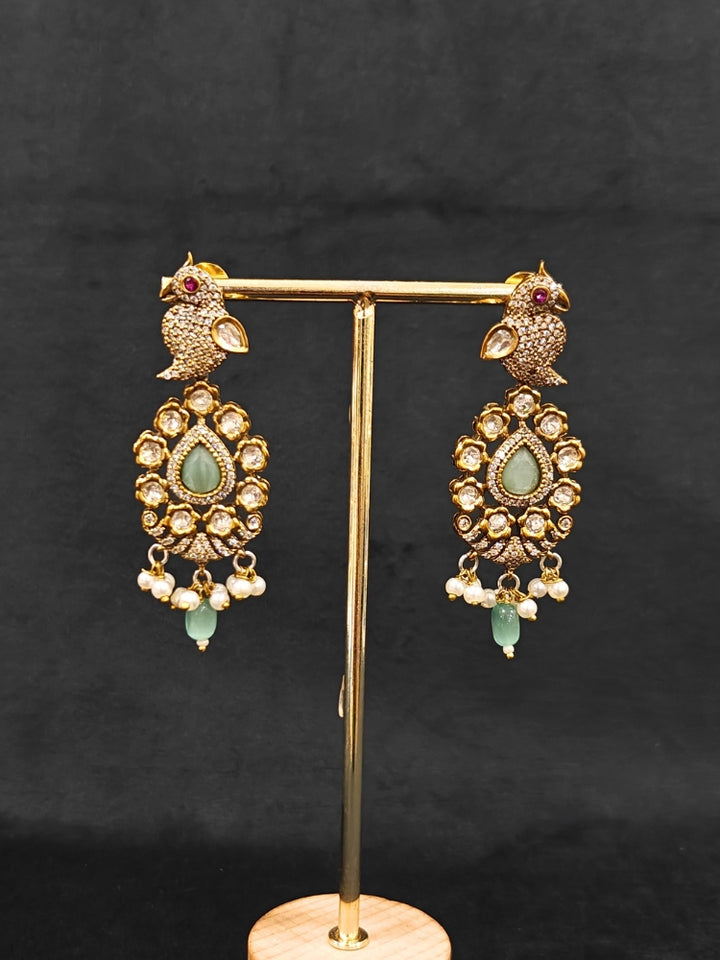 Close-up of an ornate traditional Mint Green (Mehendi Polish)  Choker Diamond jewellery set and earrings with Pearls, Tumble Beads, American Diamond, Kundan and Mint Green Colored Stones. Festive Diwali outfit styled with an American diamond artificial necklace. Close-up of high-quality  artificial American Diamond necklace craftsmanship.