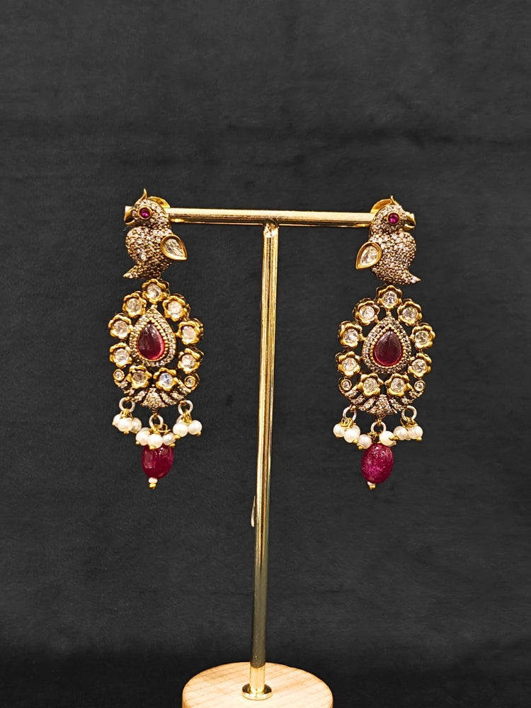 Close-up of an ornate traditional Ruby Red (Mehendi Polish)  Choker Diamond jewellery set and earrings with Pearls, Tumble Beads, American Diamond, Kundan and Ruby Red Colored Stones. Festive Diwali outfit styled with an American diamond artificial necklace. Close-up of high-quality  artificial American Diamond necklace craftsmanship.