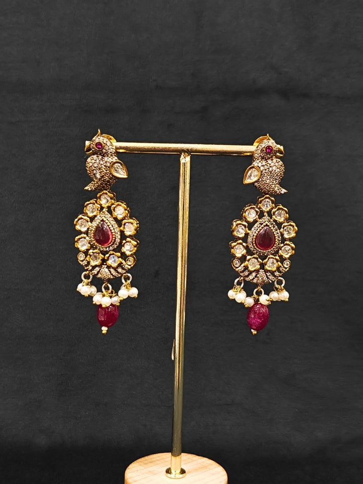 Close-up of an ornate traditional Ruby Red (Mehendi Polish)  Choker Diamond jewellery set and earrings with Pearls, Tumble Beads, American Diamond, Kundan and Ruby Red Colored Stones. Festive Diwali outfit styled with an American diamond artificial necklace. Close-up of high-quality  artificial American Diamond necklace craftsmanship.