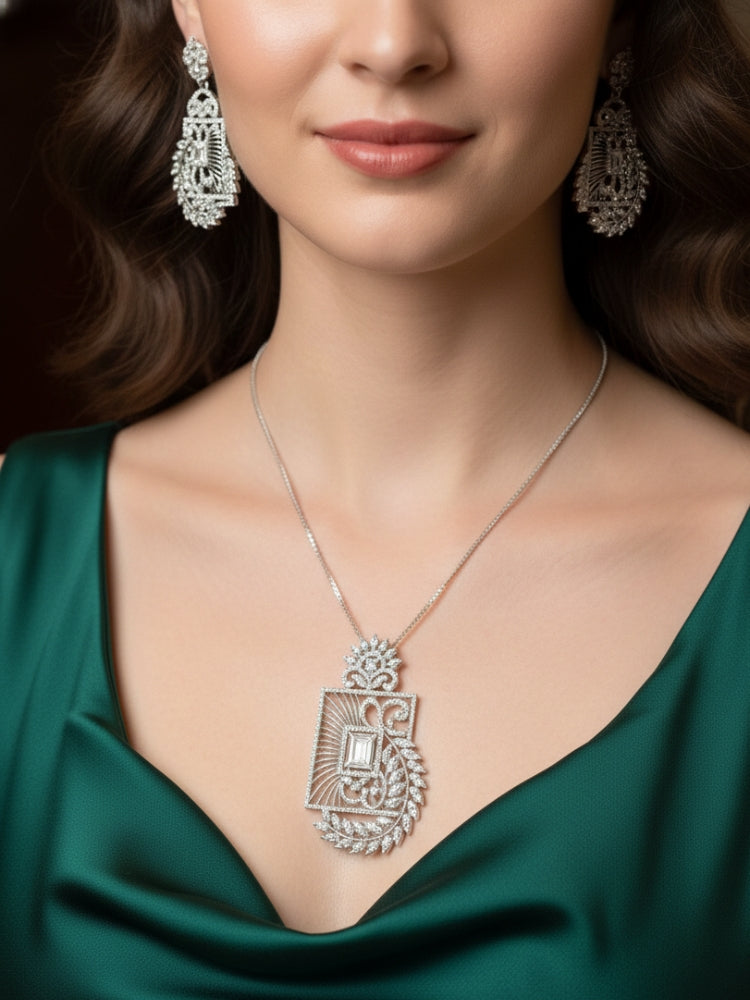 Close-up of a woman wearing an ornate Western (Silver Polish) Diamond Pendant set and earrings with American Diamonds. Elegant festive look with a high-quality imitation American diamond Pendant set. Close-up of a cocktail party look featuring a premium American diamond Pendant.
