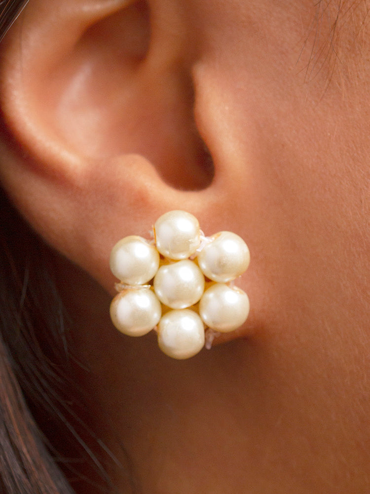 Close-up of a woman wearing an ornate Indo-Western White Pearl Layered Jewellery Set and Earring with Pearl. Indo-western outfit styled with a statement Pearl necklace set. Party wear outfit completed with a lightweight Pearl necklace.
