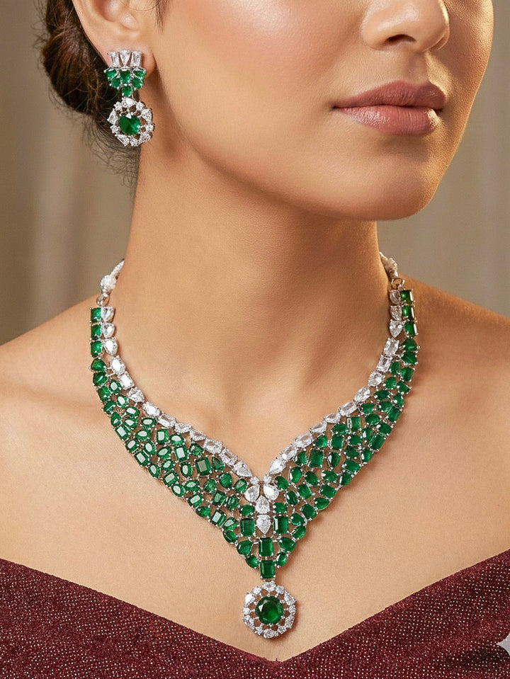 "A bride-to-be wearing an exquisite artificial diamond necklace with green colored stone and matching earrings, designed for the perfect look. This stunning artificial diamond jewelry set offers luxury and sophistication while being an affordable alternative to natural diamonds."
