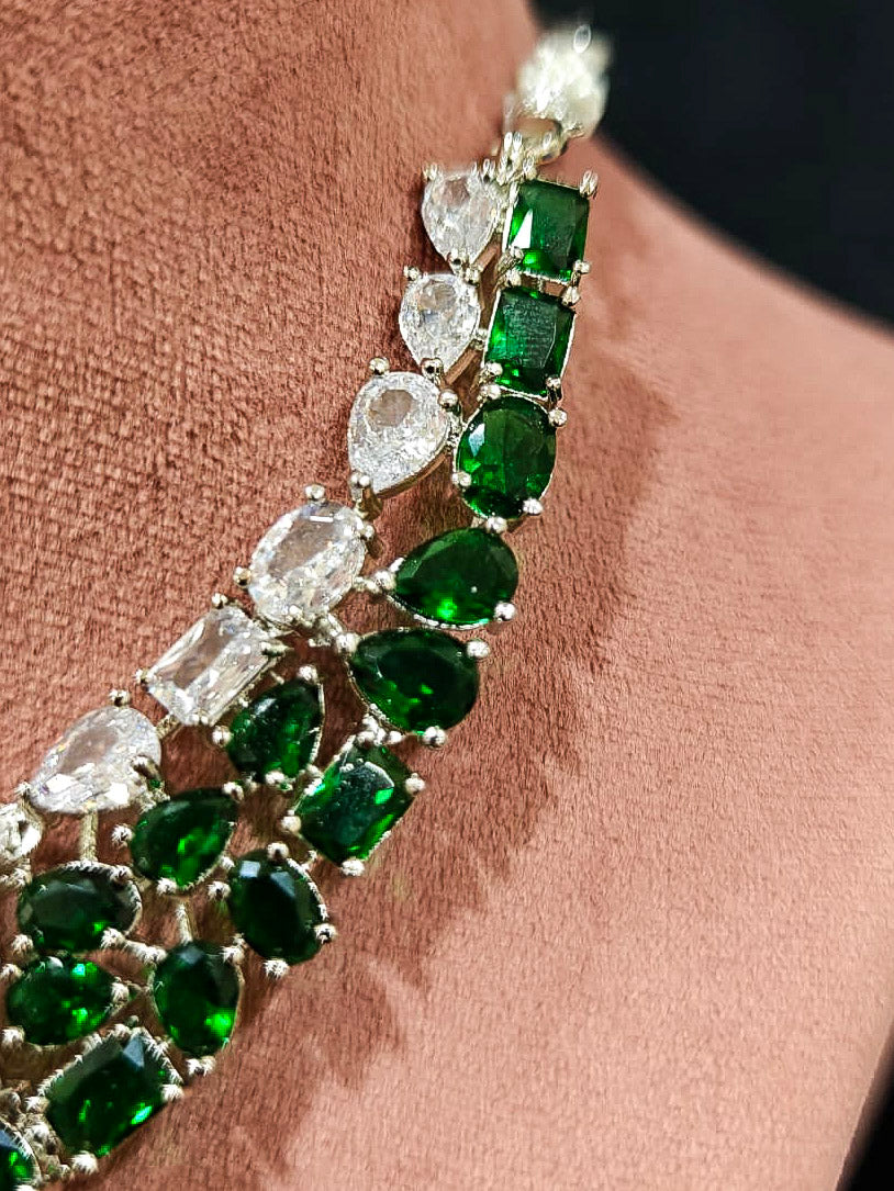 An exquisite artificial diamond necklace with green colored stone and matching earrings, designed for the perfect look. This stunning artificial diamond jewelry set offers luxury and sophistication while being an affordable alternative to natural diamonds.
