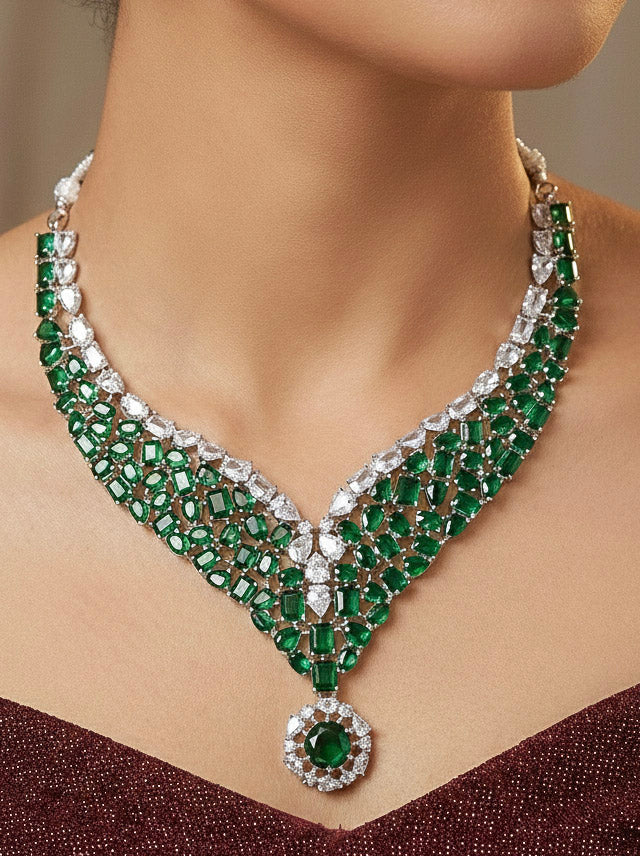 "A beautiful woman wearing an elegant artificial diamond necklace with green colored stone and matching earrings. This premium artificial diamond jewelry set is perfect for special occasions, from Indian weddings to engagement parties, offering sophisticated glamour without the high price tag."
