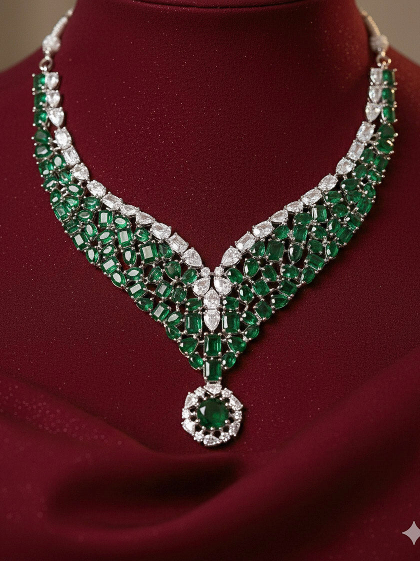 "Close-up of a woman wearing a sparkling artificial diamond necklace with green colored stone and diamond earrings set, designed to offer a radiant, elegant look for any formal occasion or Indian wedding. This affordable diamond jewelry provides a flawless, luxurious alternative to natural diamonds."
