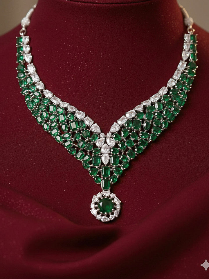 "Close-up of a woman wearing a sparkling artificial diamond necklace with green colored stone and diamond earrings set, designed to offer a radiant, elegant look for any formal occasion or Indian wedding. This affordable diamond jewelry provides a flawless, luxurious alternative to natural diamonds."
