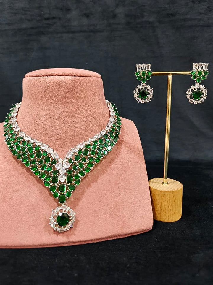 An exquisite artificial diamond necklace with green colored stone and matching earrings, designed for the perfect look. This stunning artificial diamond jewelry set offers luxury and sophistication while being an affordable alternative to natural diamonds.