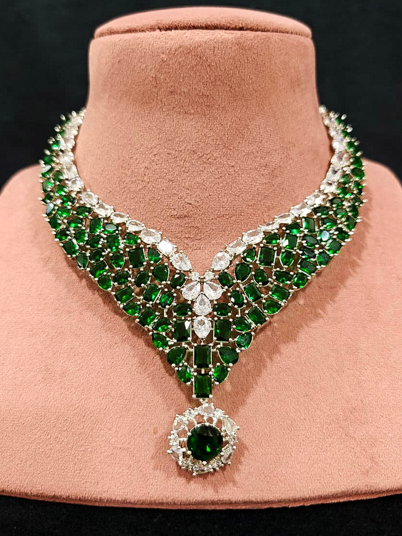 An exquisite artificial diamond necklace with green colored stone and matching earrings, designed for the perfect look. This stunning artificial diamond jewelry set offers luxury and sophistication while being an affordable alternative to natural diamonds.