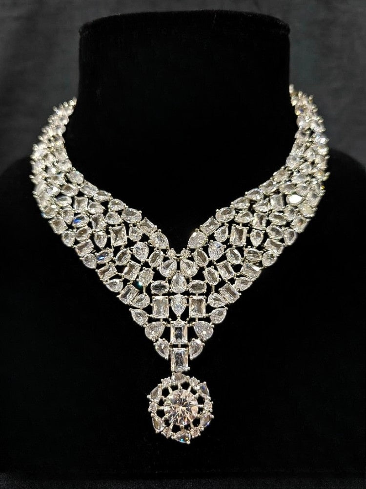 Close-up of an ornate Western American Diamond Silver Collar jewellery set and earrings with American Diamond. Elegant engagement jewelry look featuring a premium artificial American diamond necklace. Close-up of featuring an anti-tarnish American diamond artificial necklace.