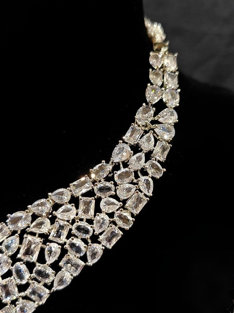 Close-up of an ornate Western American Diamond Silver Collar jewellery set and earrings with American Diamond. Elegant engagement jewelry look featuring a premium artificial American diamond necklace. Close-up of featuring an anti-tarnish American diamond artificial necklace.