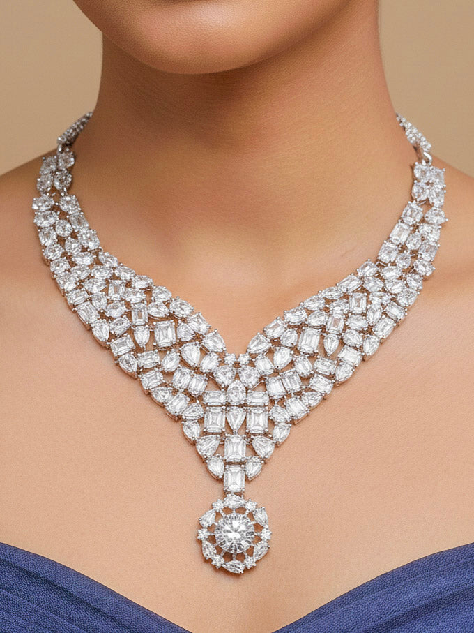 Close-up of a woman wearing an ornate Western American Diamond Silver Collar jewellery set and earrings with American Diamond. Elegant engagement jewelry look featuring a premium artificial American diamond necklace. Woman styling a statement American diamond necklace with an off-shoulder gown for a reception.