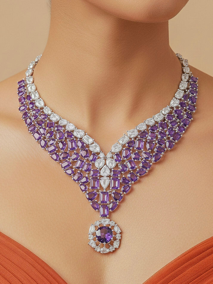 Close-up of a woman wearing an ornate Western Purple Colored Stone Silver Collar jewellery set and earrings with American Diamond and Colored Stones. Woman styling a statement Colored Stones necklace with an off-shoulder gown for a reception and Party.