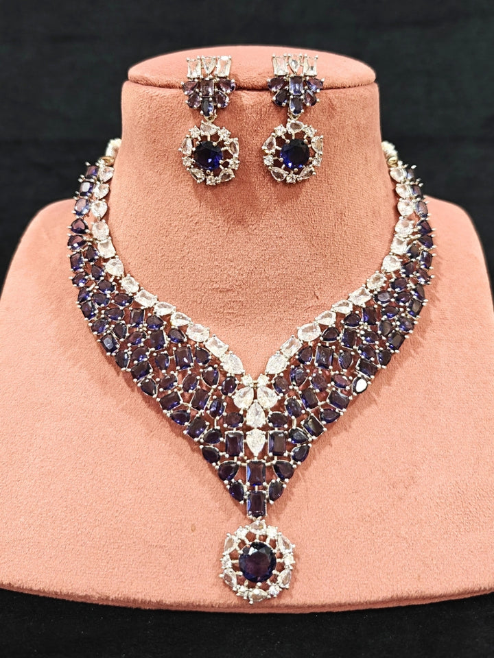 Close-up of an ornate Western Purple Colored Stones Silver Collar jewellery set and earrings with American Diamond and Colored Stones.A statement Colored Stones necklace with an off-shoulder gown for a reception and Party.