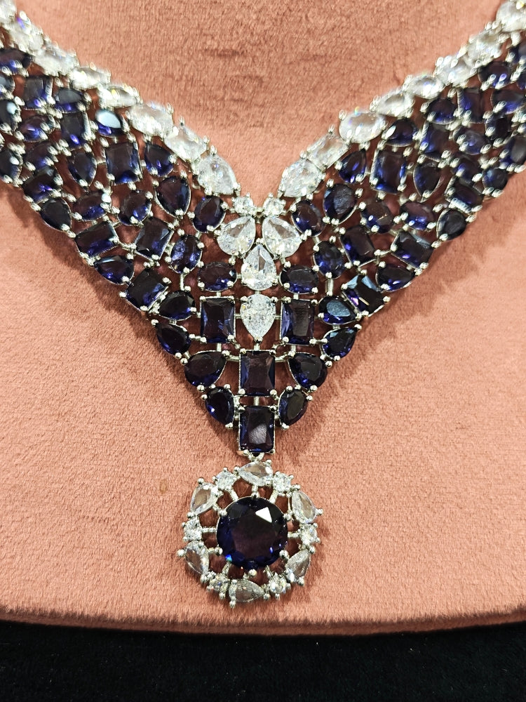 Close-up of an ornate Western Purple Colored Stones Silver Collar jewellery set and earrings with American Diamond and Colored Stones.A statement Colored Stones necklace with an off-shoulder gown for a reception and Party.