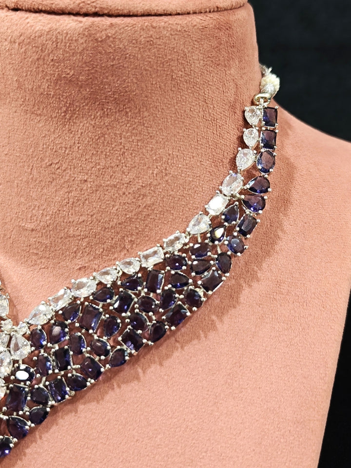 Close-up of an ornate Western Purple Colored Stones Silver Collar jewellery set and earrings with American Diamond and Colored Stones.A statement Colored Stones necklace with an off-shoulder gown for a reception and Party.