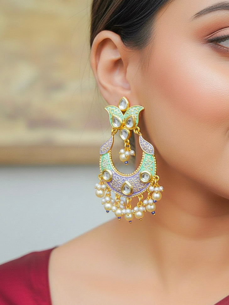 Close-up of a woman wearing an ornate traditional Sea Green Meenakari Long Earrings with Pearls, Kundan and Meenakari. Wedding guest styling a statement Meenakari artificial Earrings. Elegant reception look featuring a luxury Meenakari artificial Earrings.