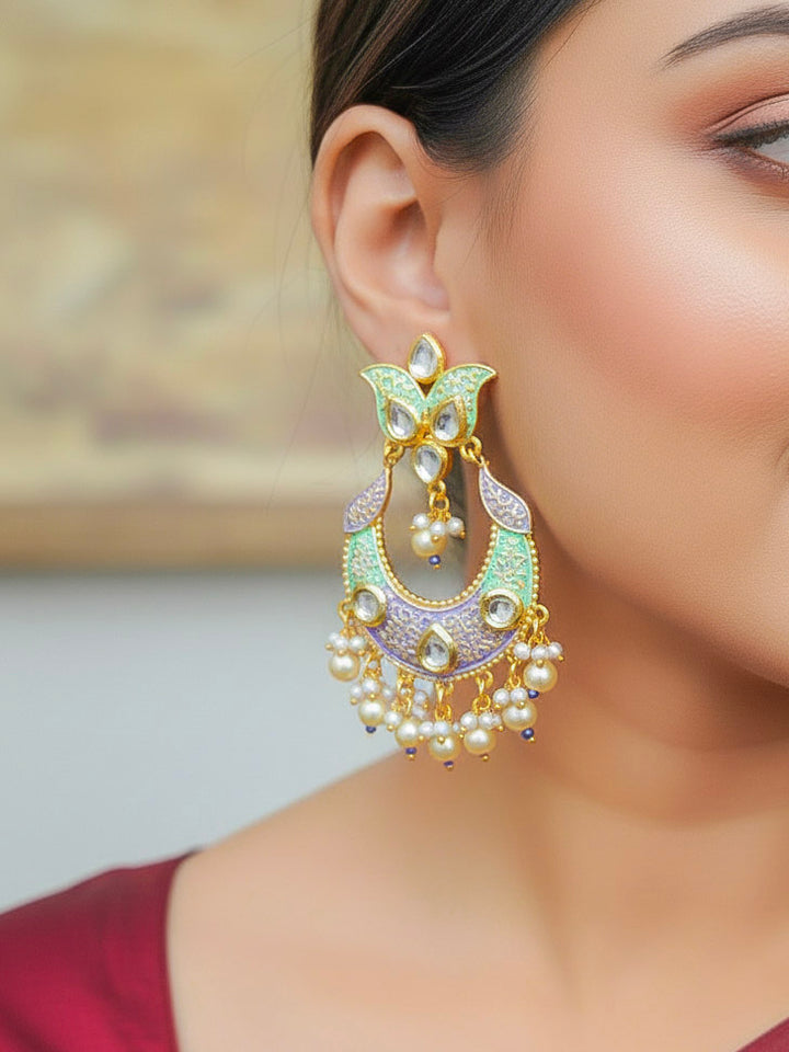 Close-up of a woman wearing an ornate traditional Sea Green Meenakari Long Earrings with Pearls, Kundan and Meenakari. Wedding guest styling a statement Meenakari artificial Earrings. Elegant reception look featuring a luxury Meenakari artificial Earrings.