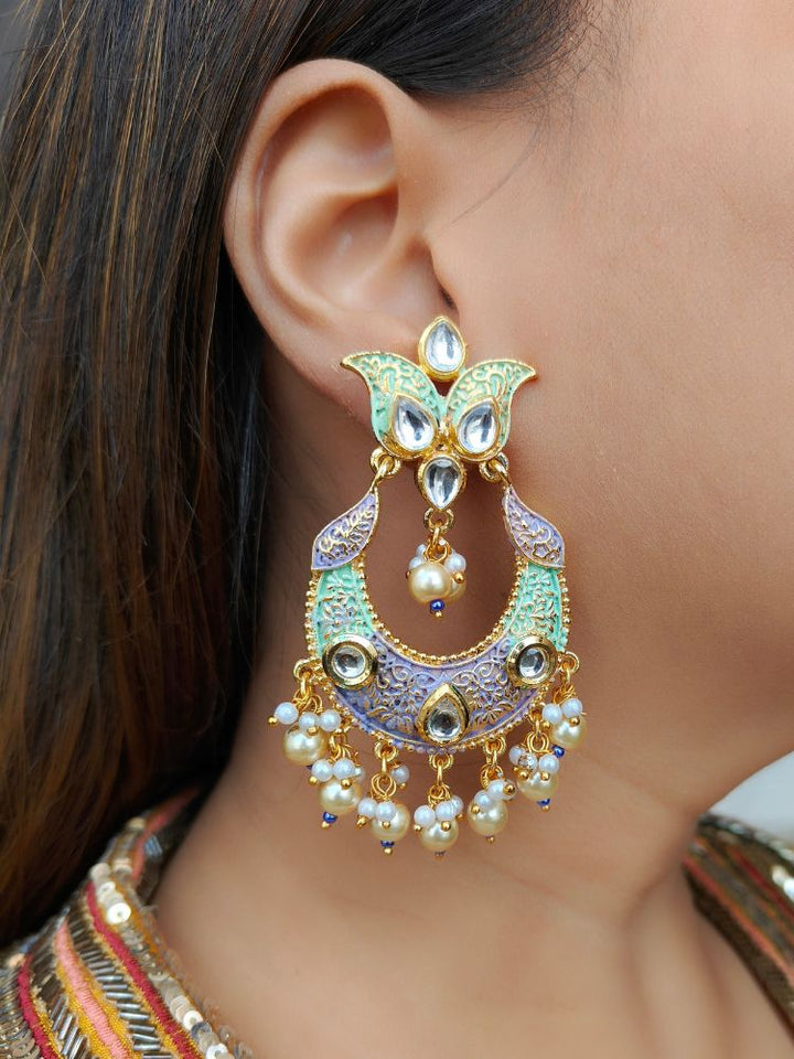 Close-up of a woman wearing an ornate traditional Sea Green Meenakari Long Earrings with Pearls, Kundan and Meenakari. Wedding guest styling a statement Meenakari artificial Earrings. Elegant reception look featuring a luxury Meenakari artificial Earrings.