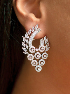 Close-up of a woman wearing an ornate Western (Silver Polish) Diamond  Earrings with American Diamond. Cocktail party outfit paired with sparkling artificial American Diamond earrings. Close-up of sparkling American diamond earrings for party wear.