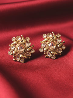 Eliza Earrings showcase intricate floral designs with reverse American diamond accents. Close-up of anti-tarnish artificial Studs earrings for festive celebrations. Indo-western dress styled with lightweight artificial Studs Earrings.