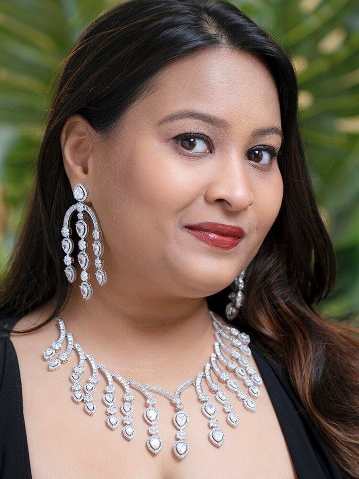 A stunning woman wearing a glamorous artificial diamond necklace paired with chic earrings, perfect for bridal wear. This high-quality artificial diamond jewelry set is the ideal choice for modern brides looking for a budget-friendly option with timeless sparkle.