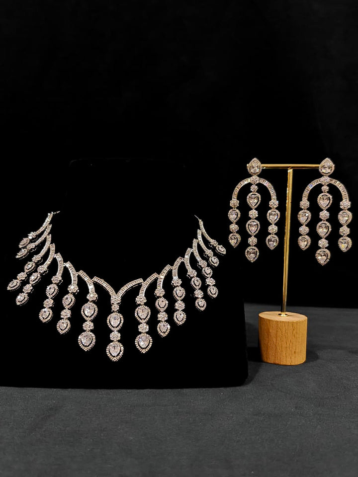 An exquisite artificial diamond necklace and matching earrings, designed for the perfect engagement look. This stunning artificial diamond jewelry set offers luxury and sophistication while being an affordable alternative to natural diamonds.