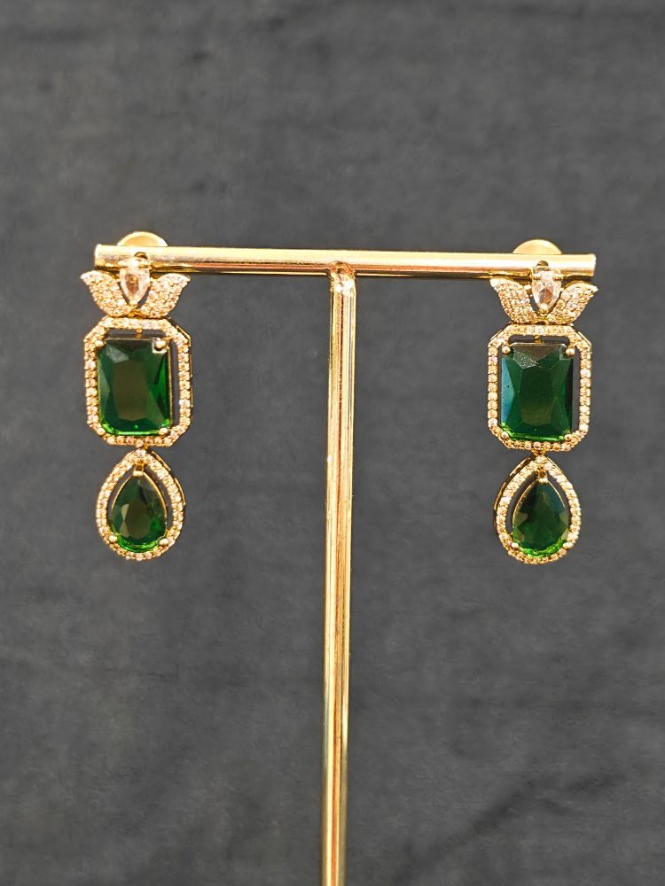 A stunning affordable artificial diamond and emerald green colored stone necklace and matching earrings set, perfect for wedding guests and formal events. This luxury artificial diamond jewelry provides the brilliance of real diamonds at a fraction of the cost. Festive Diwali outfit styled with an American diamond artificial necklace.