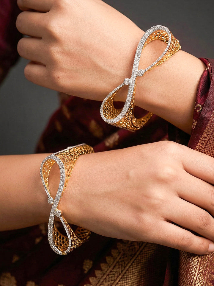 Close-up of a woman wearing an ornate Indo-western Diamond Gold Bangles with American Diamond, Filigree Work and Infinity Design. Wedding guest look completed with lightweight American Diamond artificial bangles. Perfect American Diamond necklace set for weddings and festivals.