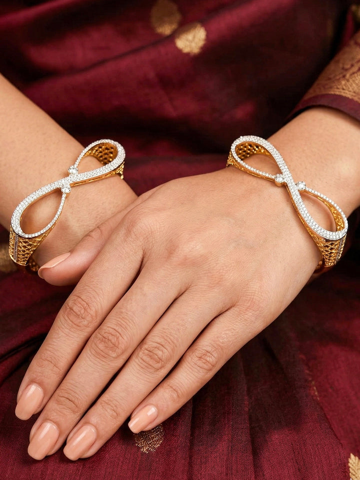 Close-up of a woman wearing an ornate Indo-western Diamond Gold Bangles with American Diamond, Filigree Work and Infinity Design. Wedding guest look completed with lightweight American Diamond artificial bangles. Perfect American Diamond necklace set for weddings and festivals.