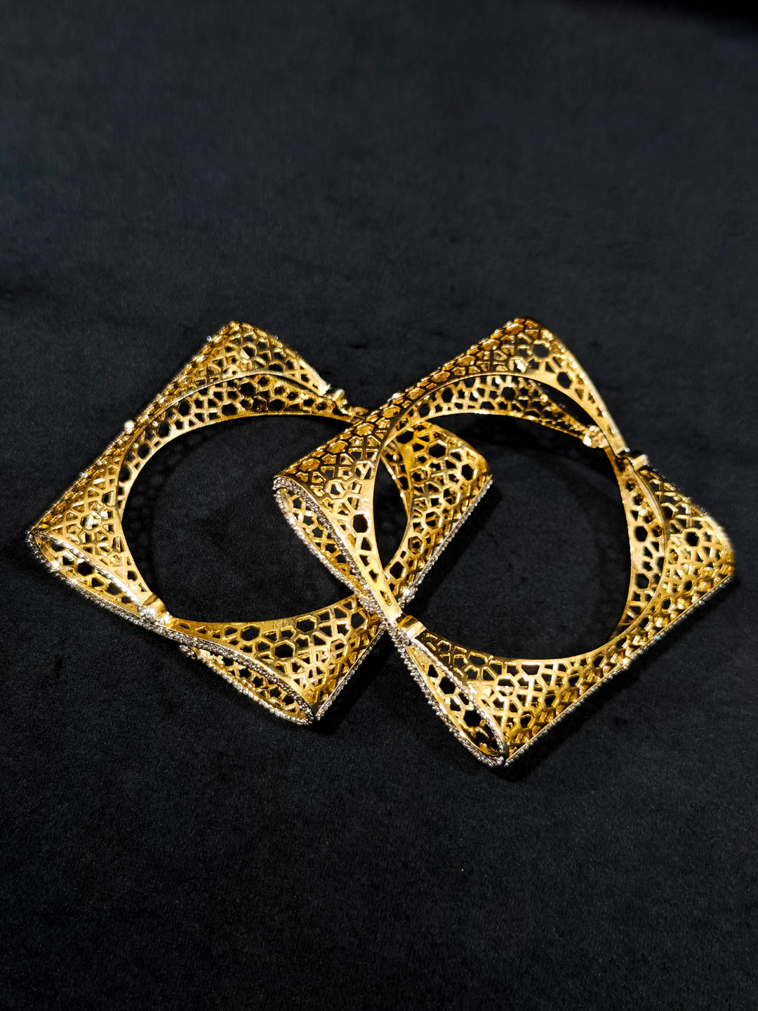 Close-up of an ornate Indo-western Diamond Gold Bangles with American Diamond, Filigree Work and Infinity Design. Wedding guest look completed with lightweight American Diamond artificial bangles. Perfect American Diamond necklace set for weddings and festivals.